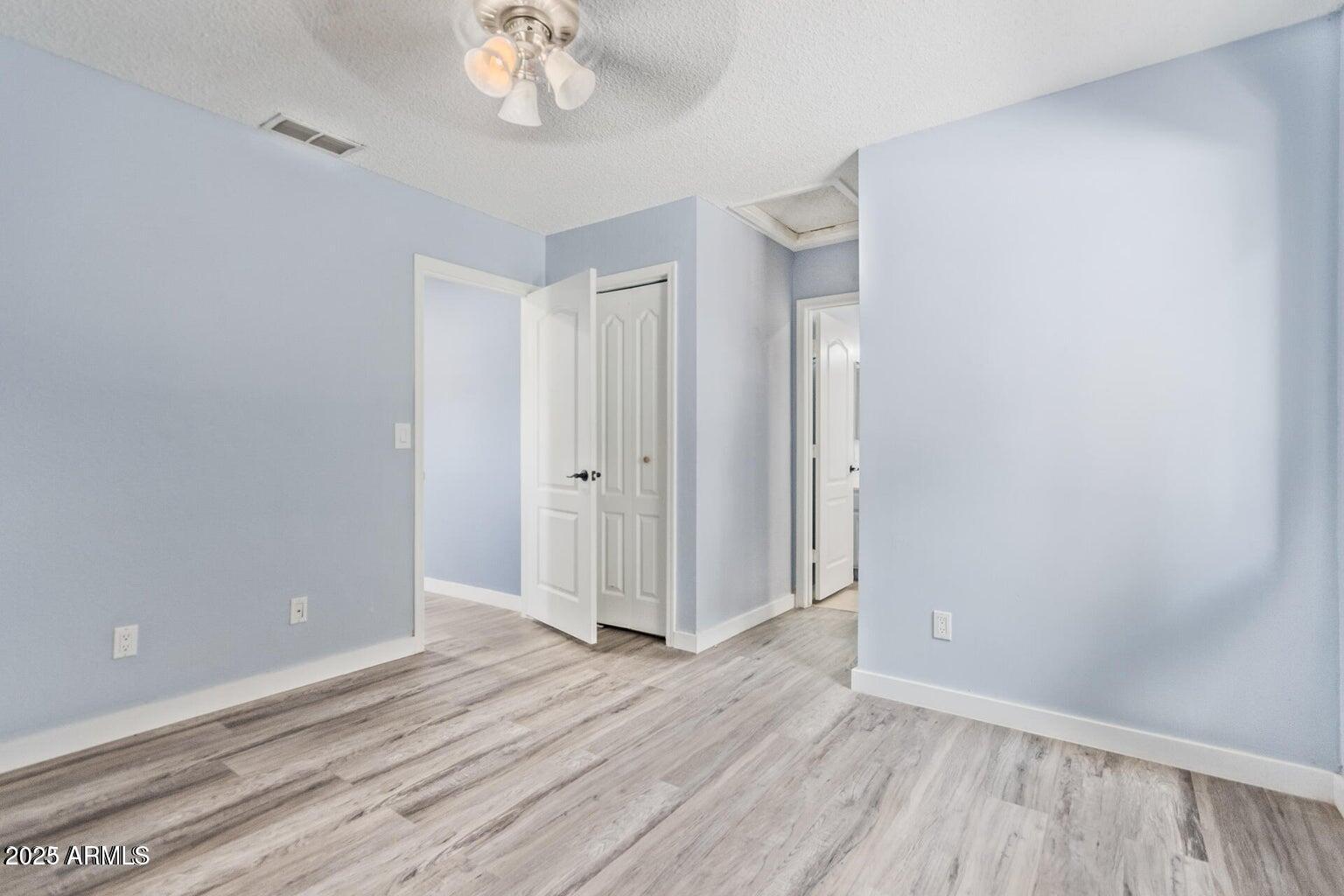 3511 East Baseline Road, Unit 1216 Phoenix, AZ 85042 - Photo 9 of 11 wooden floor in an empty room with a window
