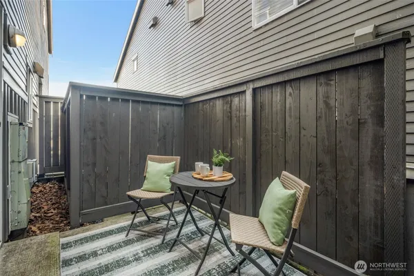 a balcony with table and chairs
