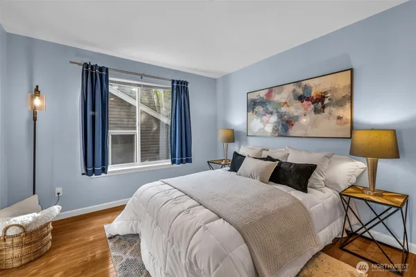 a bedroom with a bed and a painting on the wall