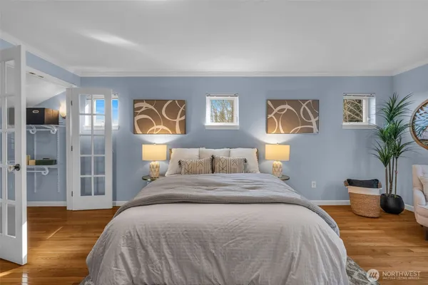 a bedroom with a bed and glass windows