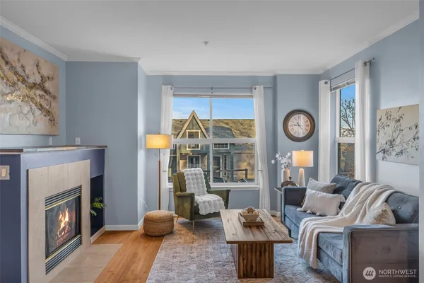 a living room with furniture a fireplace and a window