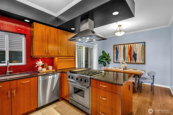 a kitchen with stainless steel appliances granite countertop a stove a sink and a microwave