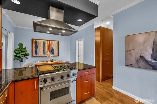 a kitchen with stainless steel appliances granite countertop a stove and a sink