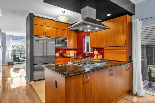 a kitchen with stainless steel appliances granite countertop a sink and a refrigerator