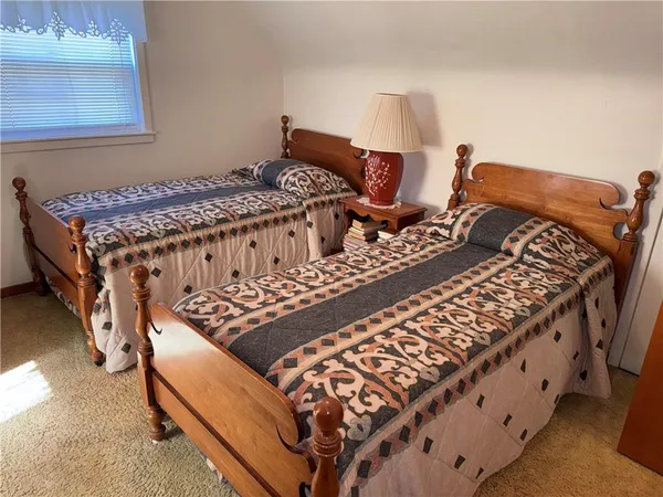 a bed sitting in a bedroom next to a window