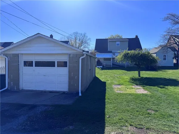 a view of a house with a small yard and wooden fence