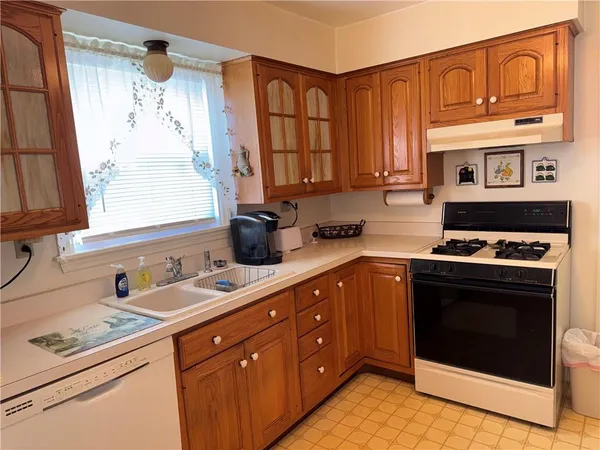 a kitchen with stainless steel appliances granite countertop a stove sink and cabinets