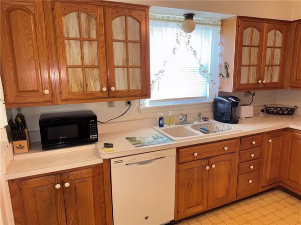 a kitchen with a sink window and cabinets