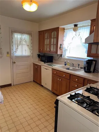 a kitchen with stainless steel appliances granite countertop a sink stove and window