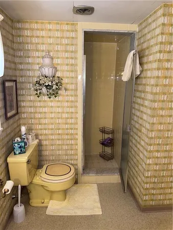 a bathroom with a toilet and a shower