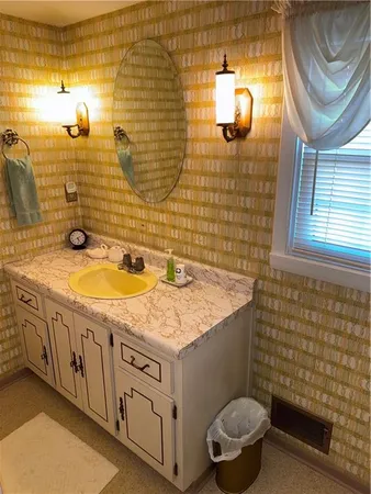 a bathroom with a sink a toilet and mirror