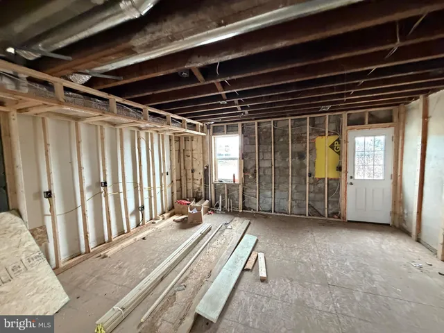 a view of a room with wooden floor and windows