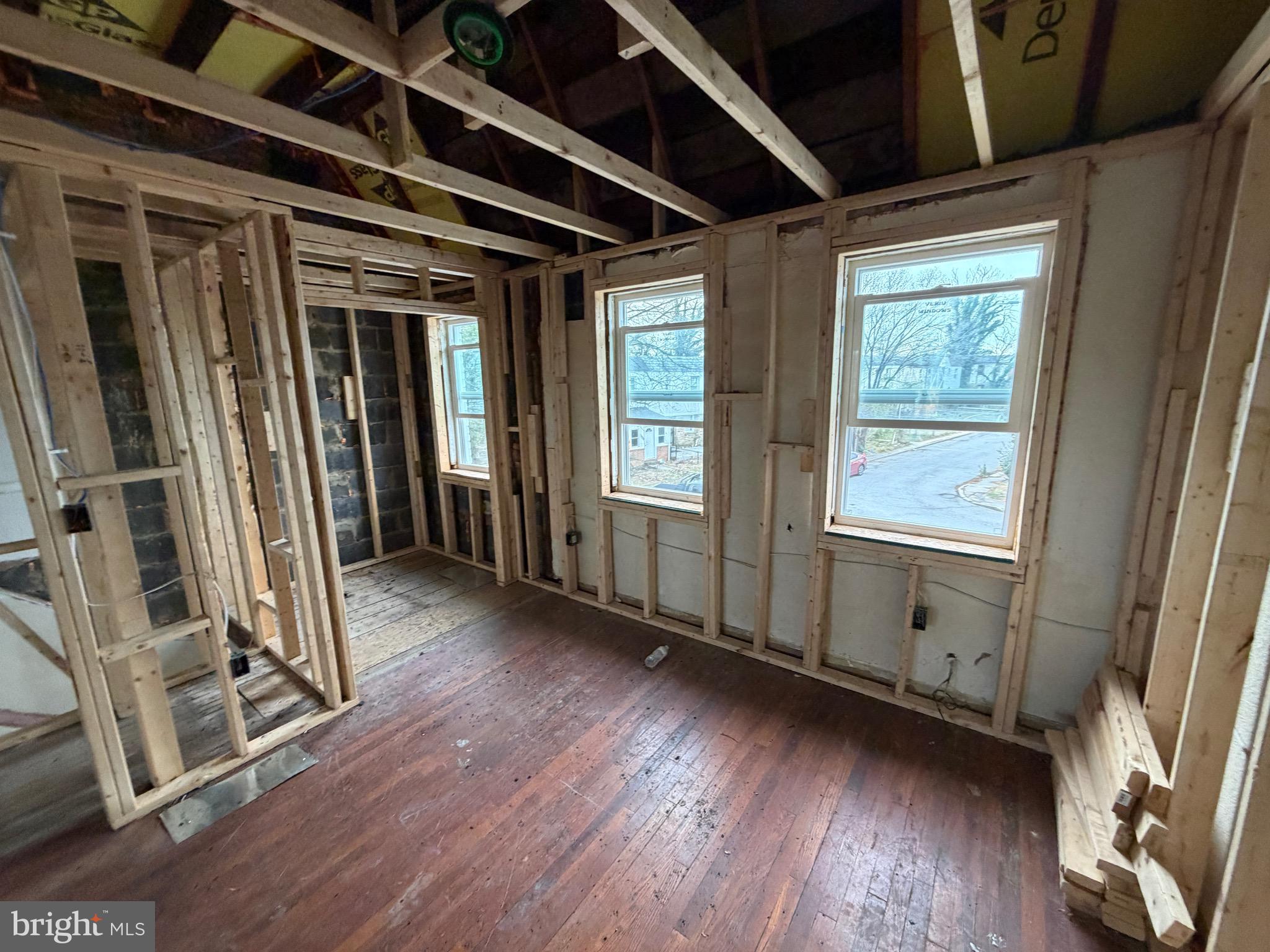 4907 Edgemere Avenue Baltimore, MD 21215 - Photo 8 of 15 a view of an empty room with wooden floor and a window