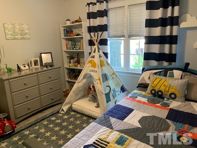 5105 Knightsbridge Way Raleigh, NC 27604 - Photo 23 of 25 a bedroom with a bed and wooden floor