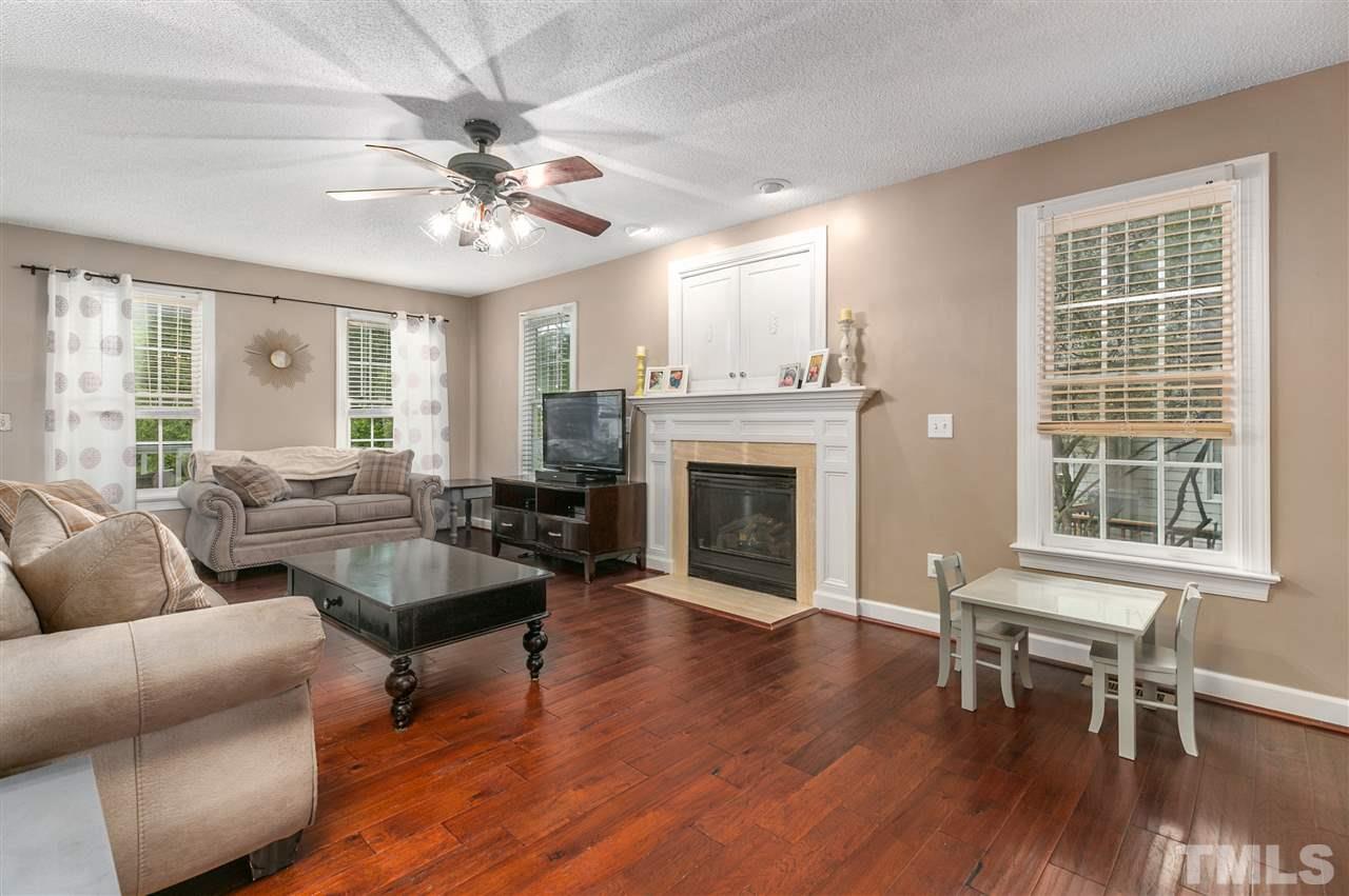 5105 Knightsbridge Way Raleigh, NC 27604 - Photo 6 of 25 a living room with furniture a fireplace and a large window