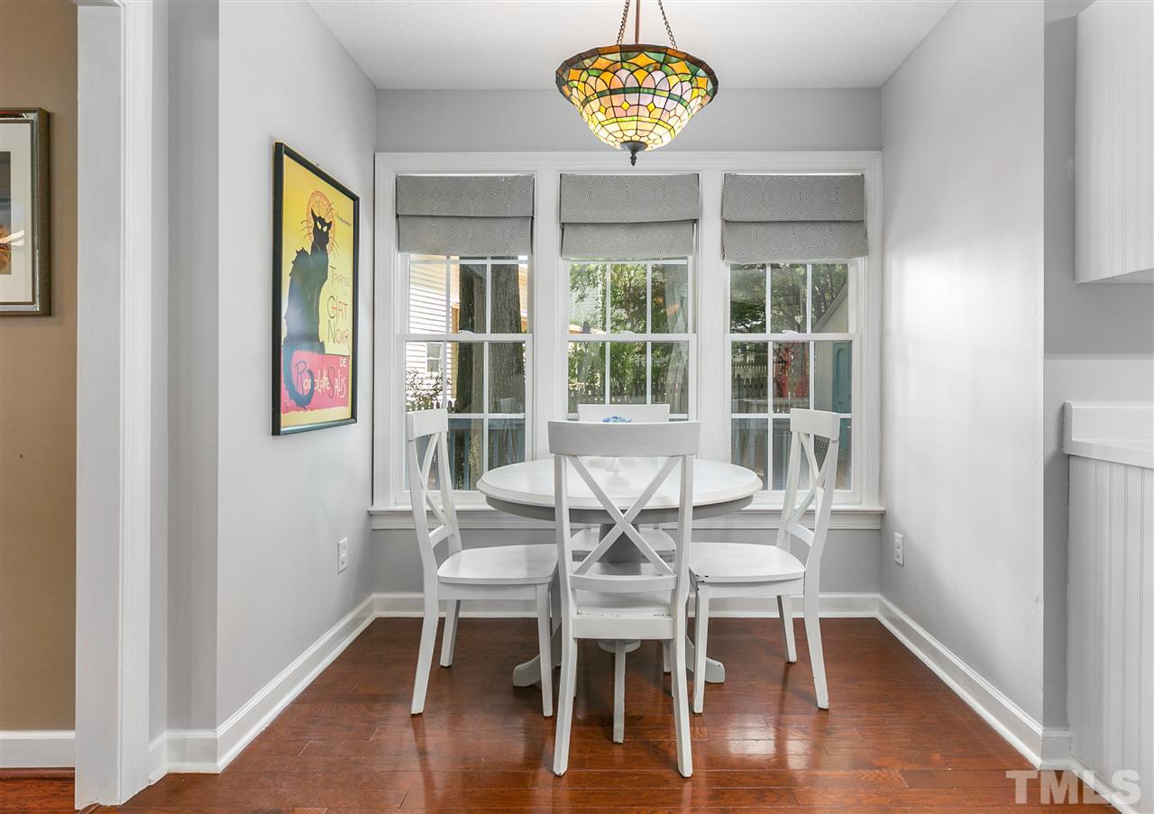 5105 Knightsbridge Way Raleigh, NC 27604 - Photo 8 of 25 a view of a dining room with furniture wooden floor and a chandelier