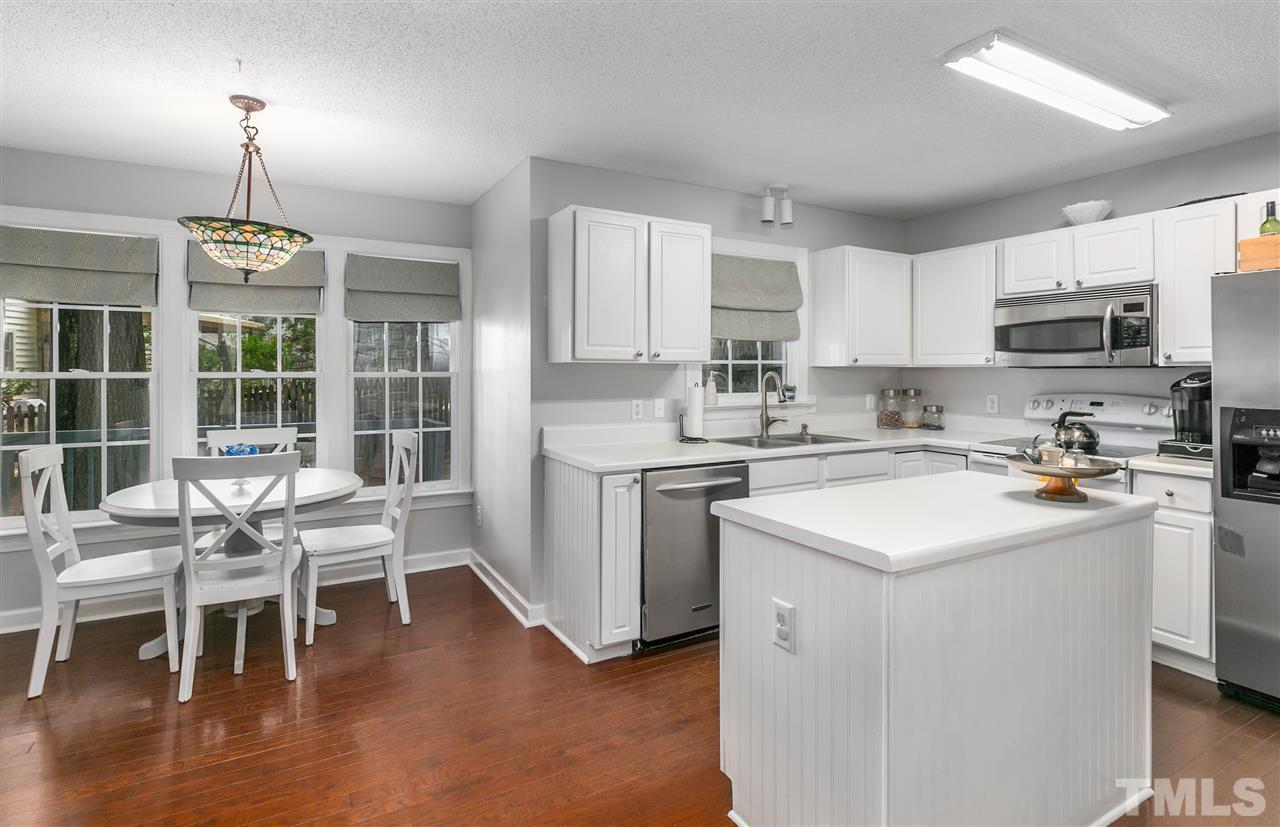 5105 Knightsbridge Way Raleigh, NC 27604 - Photo 10 of 25 a kitchen with a sink stainless steel appliances and white cabinets