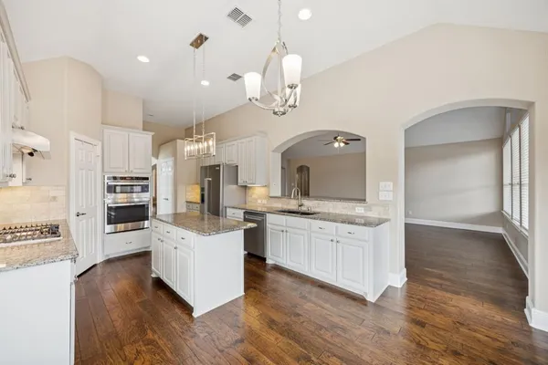 a kitchen with stainless steel appliances a stove top oven and sink