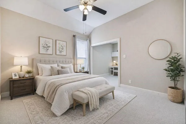 a spacious bedroom with a bed and a chandelier