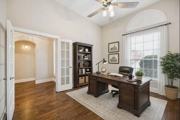 a view of a workspace with furniture and a window
