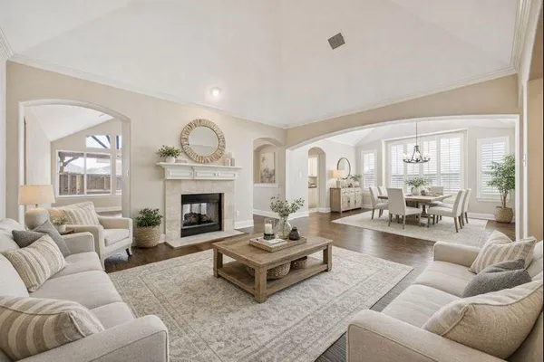 a living room with furniture fireplace and a large window