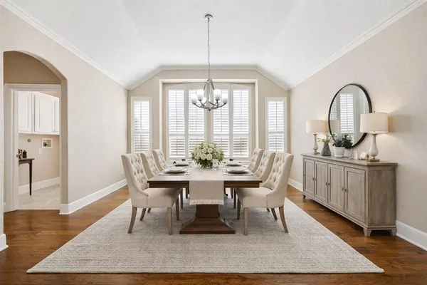 a dining room with furniture a rug and wooden floor