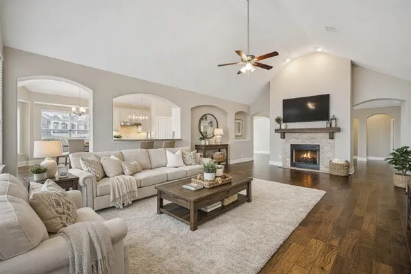 a living room with furniture a fireplace and a flat screen tv