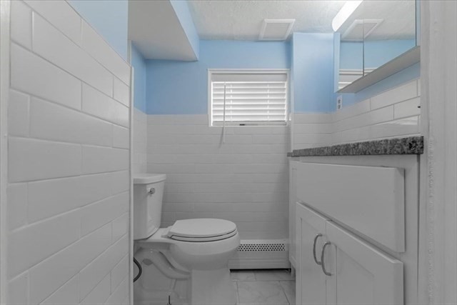 23 Sachem Street Revere, MA 02151 - Photo 13 of 17 a bathroom with a toilet a sink a window and shower