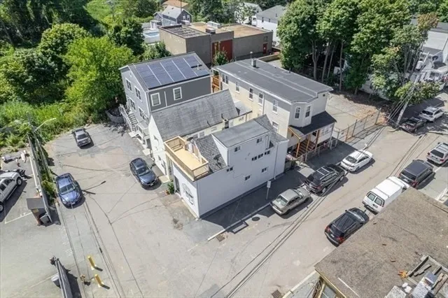 an aerial view of a house with yard