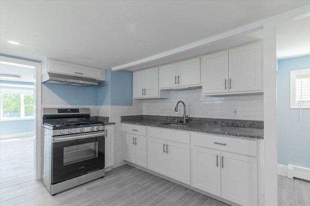 23 Sachem Street Revere, MA 02151 - Photo 3 of 17 a kitchen with granite countertop white cabinets and stainless steel appliances