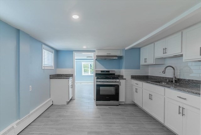23 Sachem Street Revere, MA 02151 - Photo 4 of 17 a kitchen with granite countertop a sink stove and cabinets