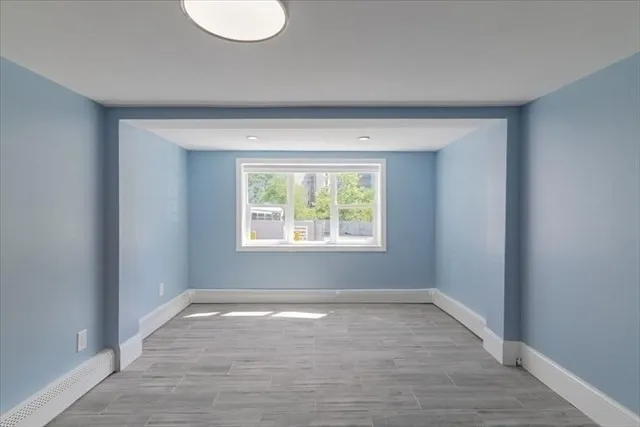 wooden floor in an empty room with a window