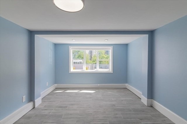 23 Sachem Street Revere, MA 02151 - Photo 5 of 17 wooden floor in an empty room with a window