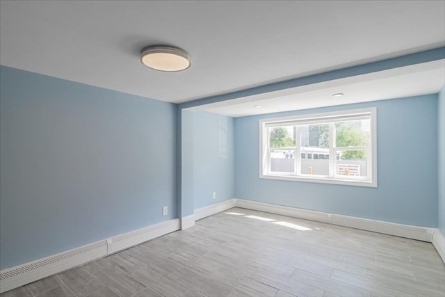 23 Sachem Street Revere, MA 02151 - Photo 6 of 17 an empty room with wooden floor and windows