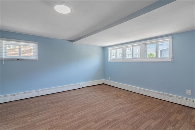 23 Sachem Street Revere, MA 02151 - Photo 7 of 17 a view of an empty room with wooden floor and a window