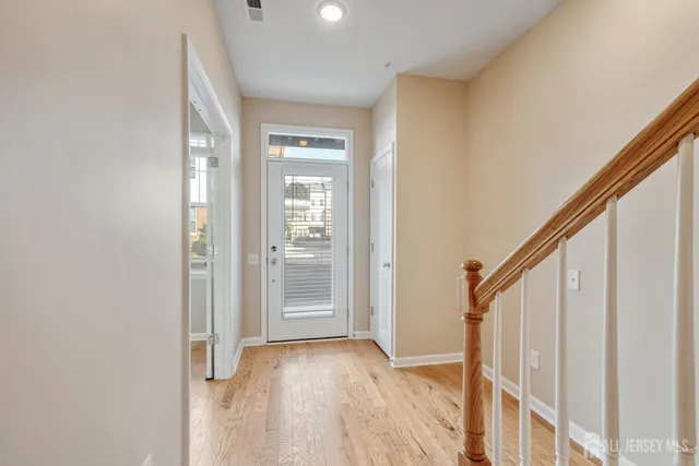 a view of an entryway with wooden floor