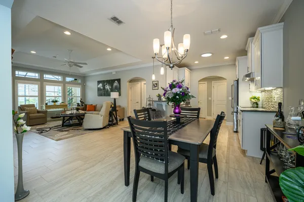 a living room with furniture and a dining table