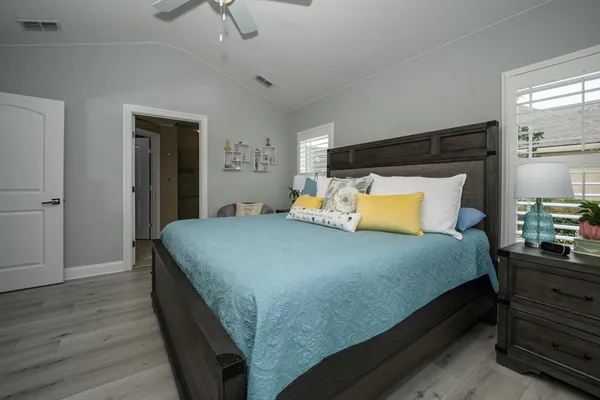 a bedroom with a large bed and a chandelier