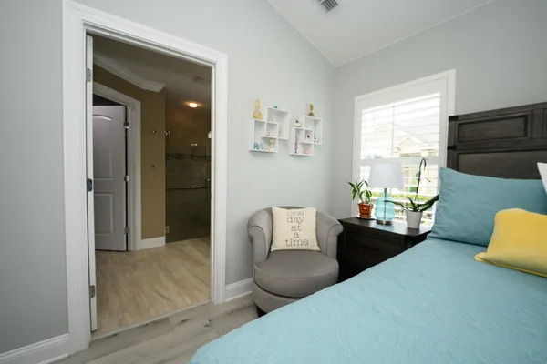a bedroom with a bed and a chandelier