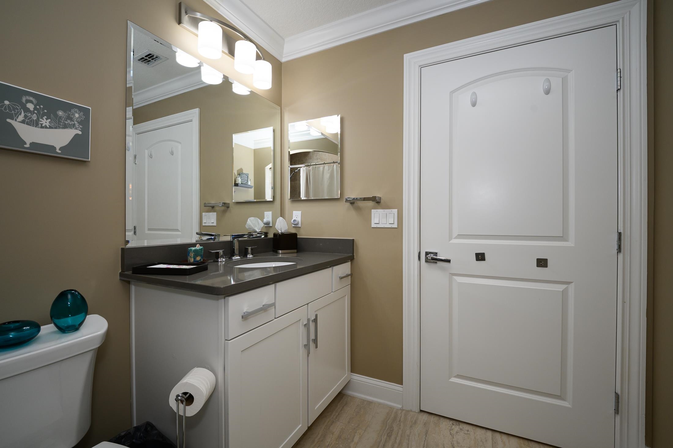 68 Ocale Court St. Augustine, FL 32084 - Photo 48 of 67 a bathroom with a granite countertop sink a toilet and mirror