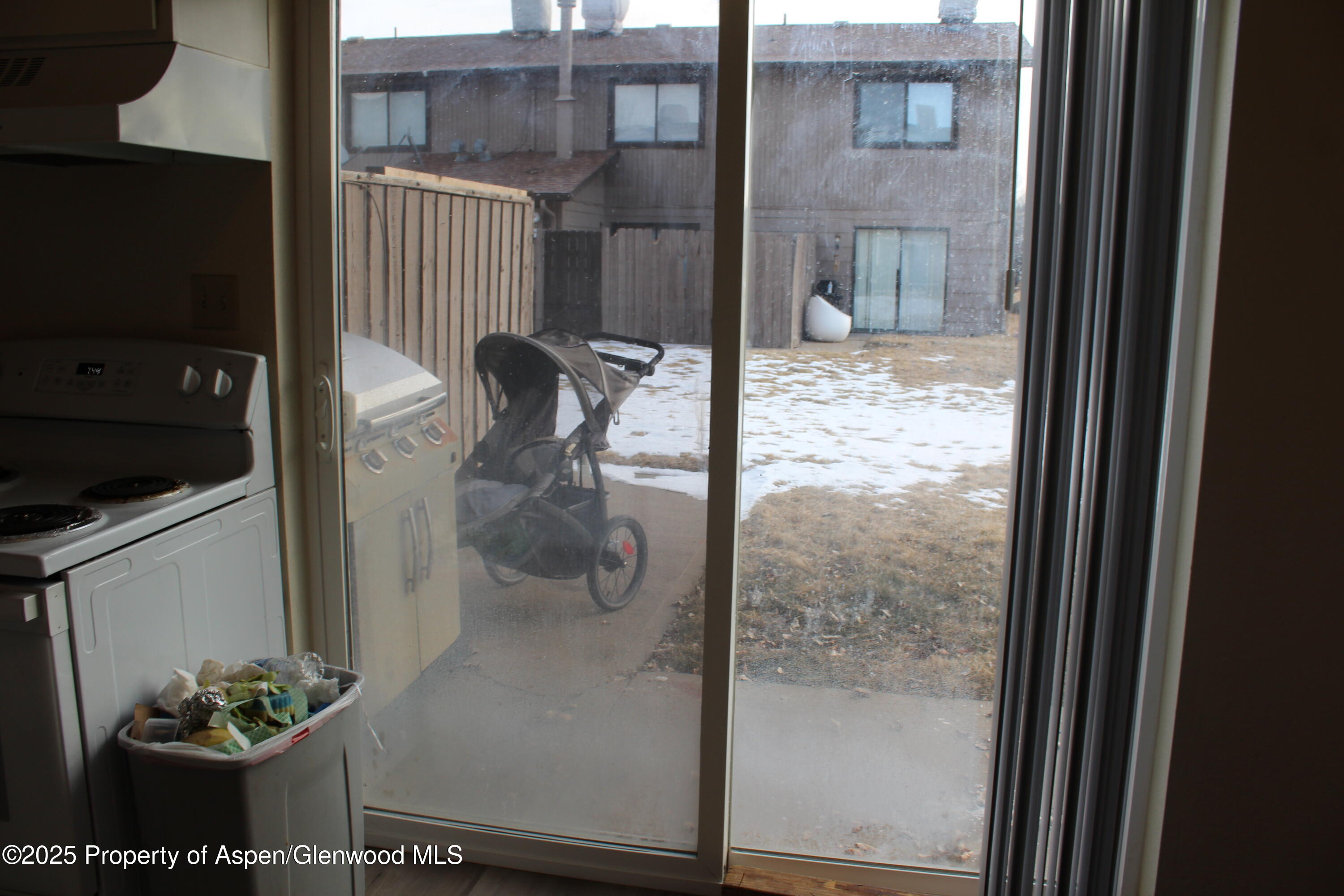 2404 West Avenue Rifle, CO 81650 - Photo 6 of 8 a bathroom with a glass shower door and a wooden floor