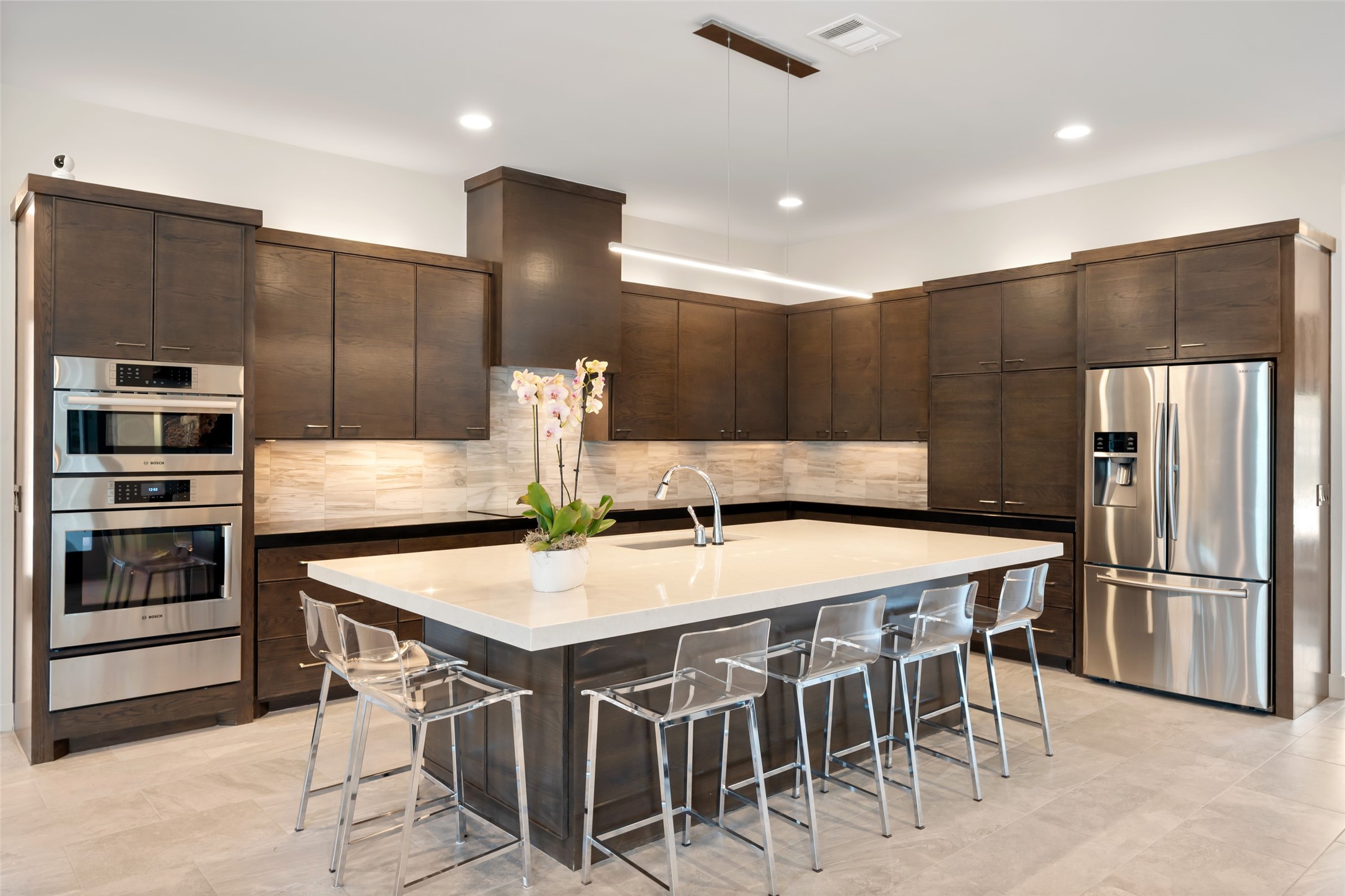 24902 Delaney Knoll Spring, TX 77389 - Photo 8 of 49 a kitchen with kitchen island a refrigerator and a stove