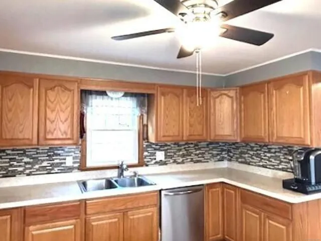 a kitchen with stainless steel appliances granite countertop a sink and refrigerator