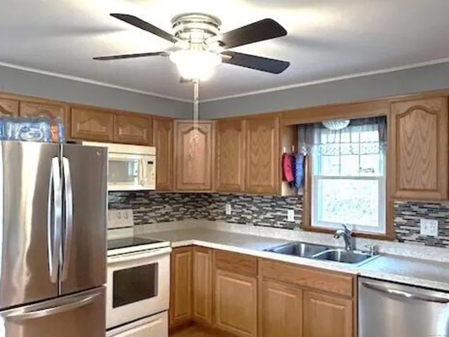 a kitchen with a refrigerator and a sink