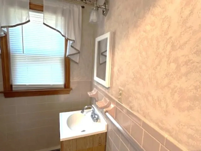 a white toilet sitting next to a shower