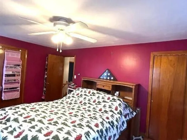 a bed sitting in a bedroom with a bed and a chandelier