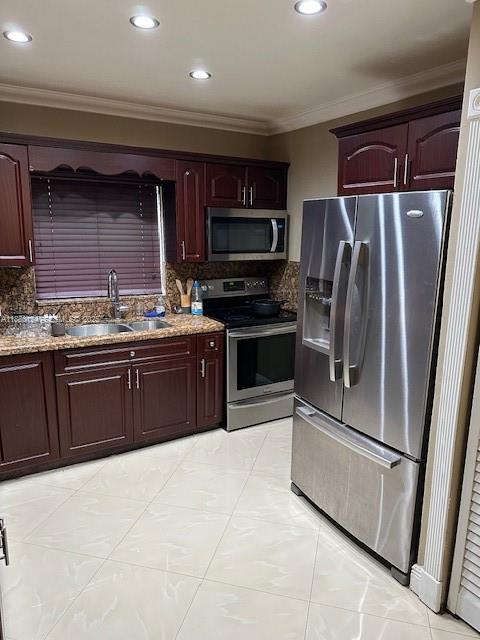 1619 Northwest 52nd Street, Unit 1 Miami, FL 33142 - Photo 6 of 16 a kitchen with stainless steel appliances granite countertop a stove top oven a sink and a refrigerator