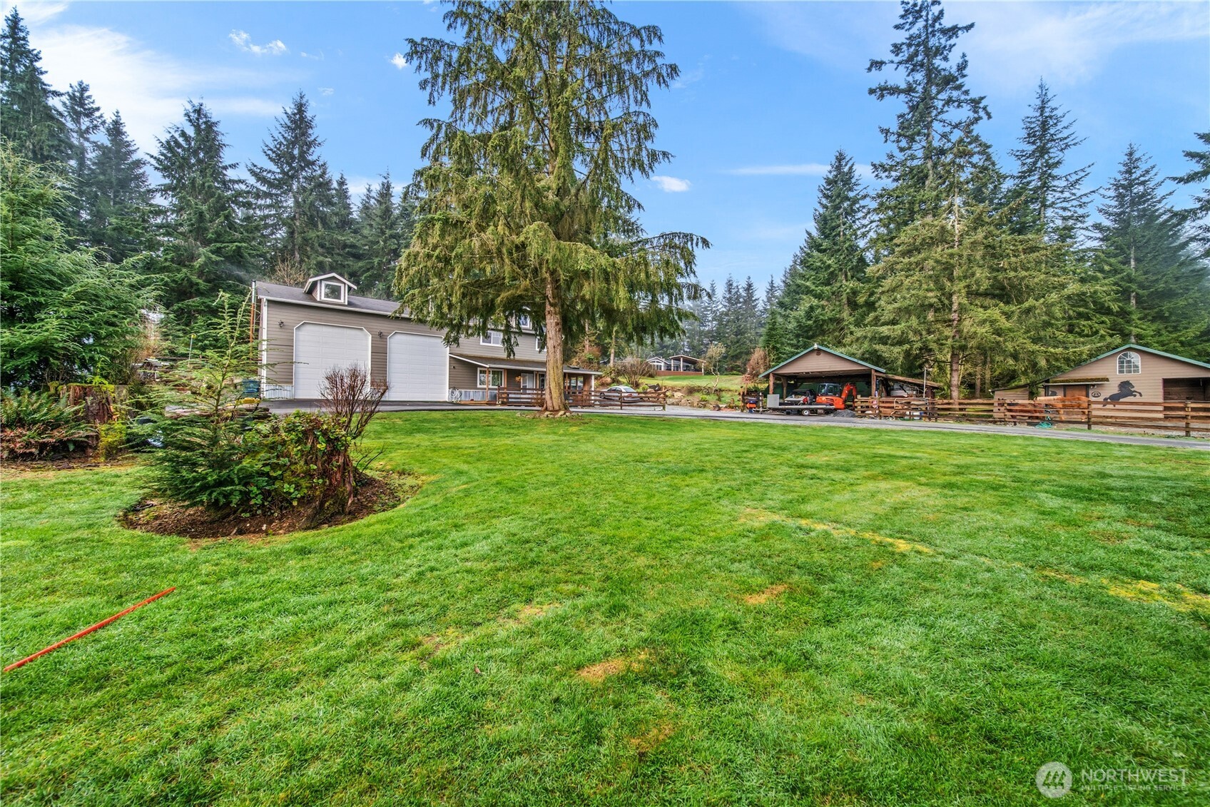 7516 Skinner Road Granite Falls, WA 98252 - Photo 22 of 40 a view of a house with a yard and sitting area