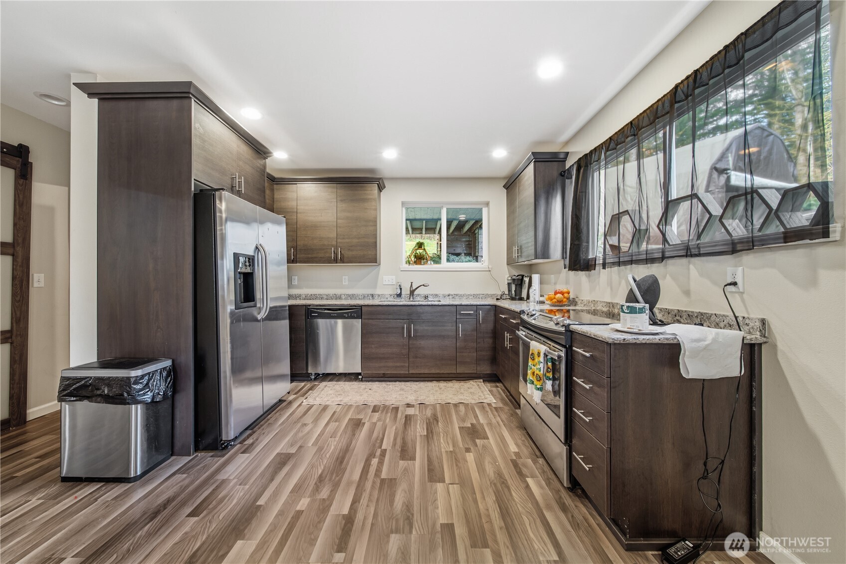 7516 Skinner Road Granite Falls, WA 98252 - Photo 23 of 40 a kitchen with stainless steel appliances granite countertop a lot of counter space and wooden floors