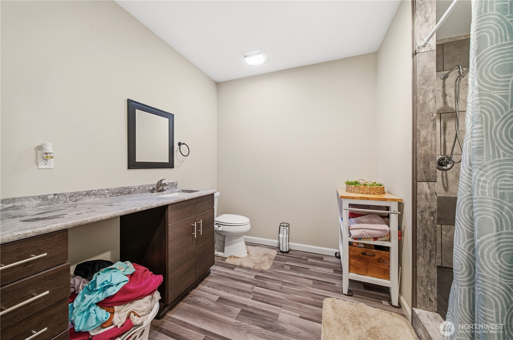7516 Skinner Road Granite Falls, WA 98252 - Photo 29 of 40 a spacious bathroom with a granite countertop sink and a mirror